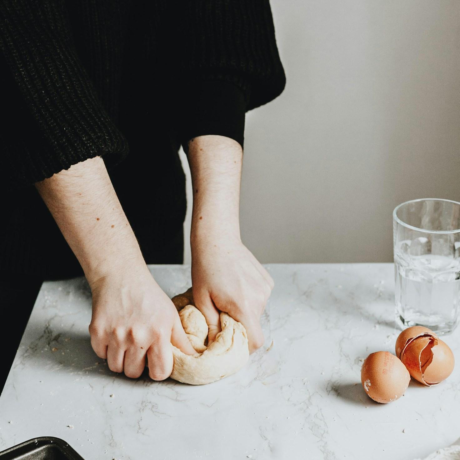 Community members collaborating in a modern kitchen space, sharing recipes and cooking techniques